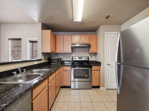 a kitchen with granite counter tops and stainless steel appliances