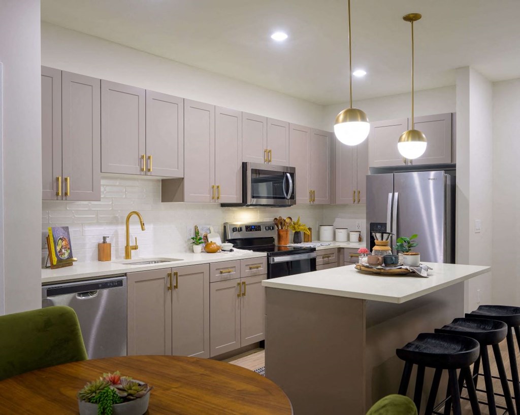 Kitchen with white cabinets and a counter top at the Moxley in Fairfax VA