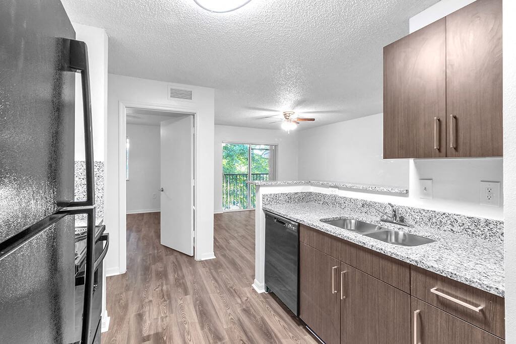 Kitchen with cabinets and fridge at Cedar Grove Apartments in Miami Gardens FL