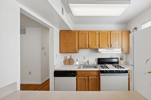 A kitchen with wooden cabinets and a black stove top oven.