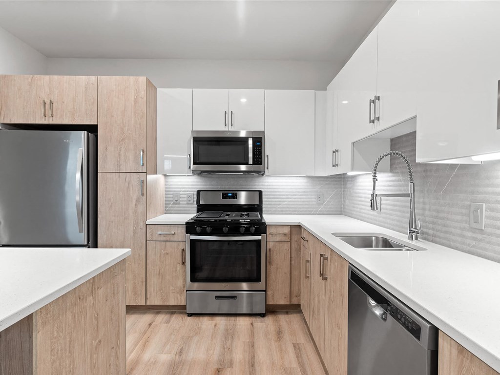 Light kitchen scheme with ligth wood cabinets at VERO Apartments in Chelsea MA