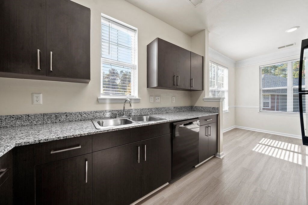 Kitchen with cabinets and dining area at Grand Oaks in Chester VA