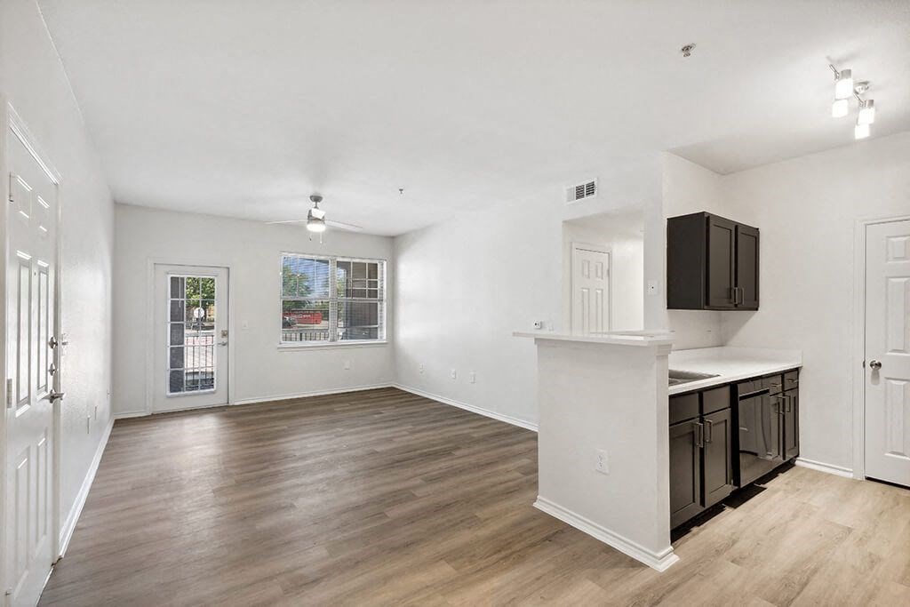 View of living room from kitchen at Bonito Parque Apartments in San Antonio TX
