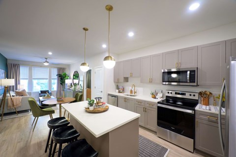 a kitchen and dining area with a white counter top