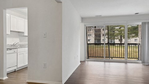 an empty living room with a view of a balcony