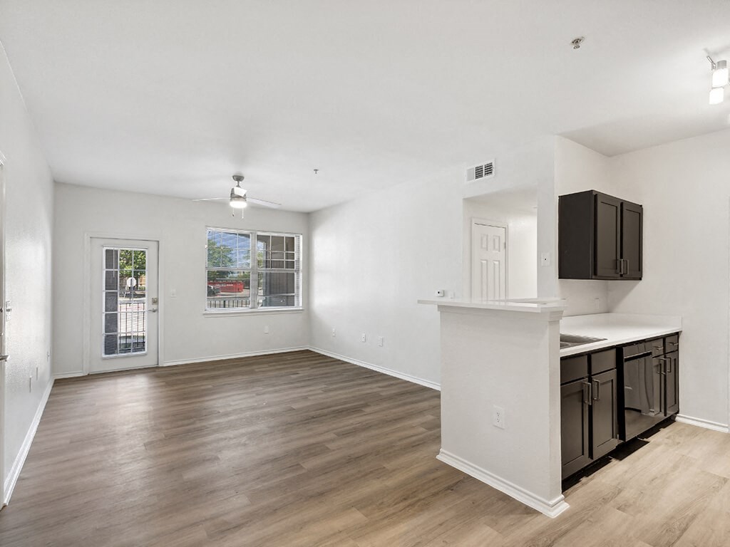 Kitchen and Living room at Bonito Parque Apartments in San Antonio, TX