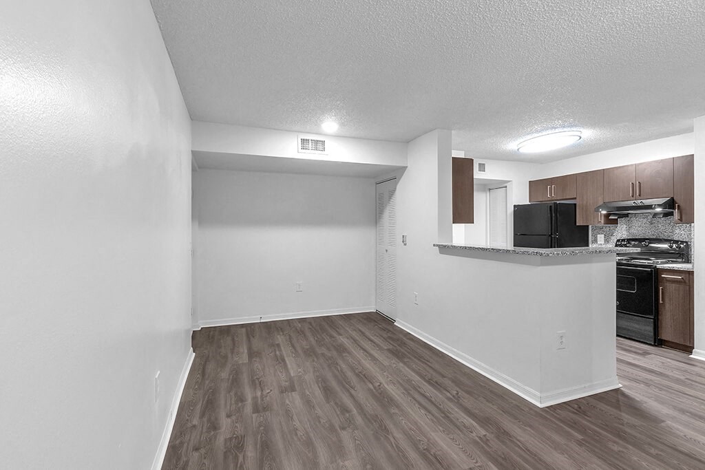 Living room with view of kitchen at Cedar Grove Apartments in Miami Gardens FL