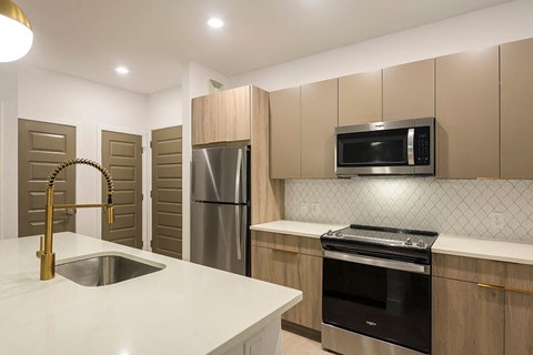 a kitchen with stainless steel appliances and a white counter top