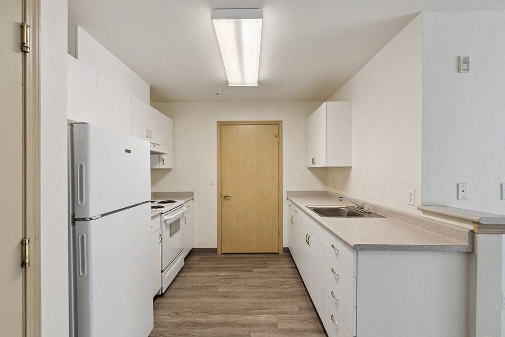 a kitchen with white appliances and white cabinets