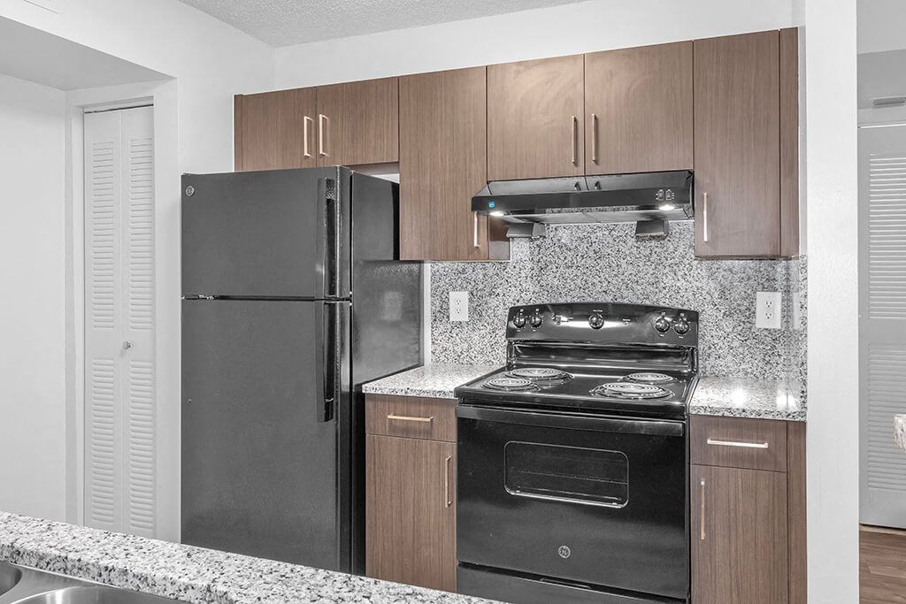 Kitchen cabinets at Cedar Grove Apartments in Miami Gardens FL