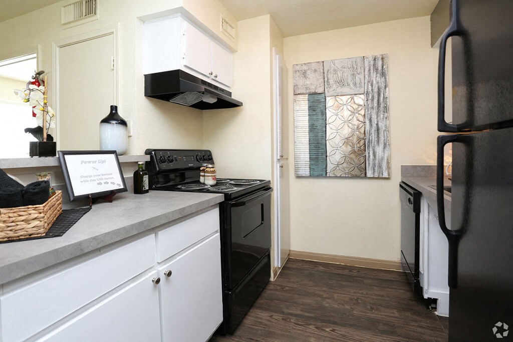 Kitchen with fridge and stove at Forest Creek Apartments in Houston TX