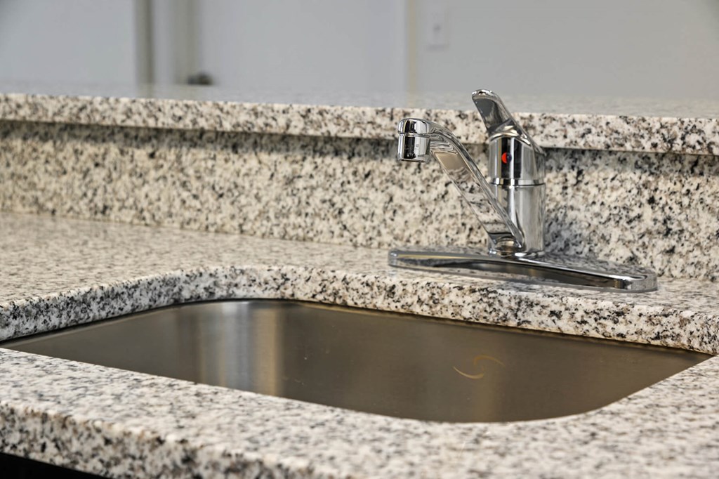 Granite kitchen counter top at Brenton at Abbey Park Apartments in West Palm Beach FL