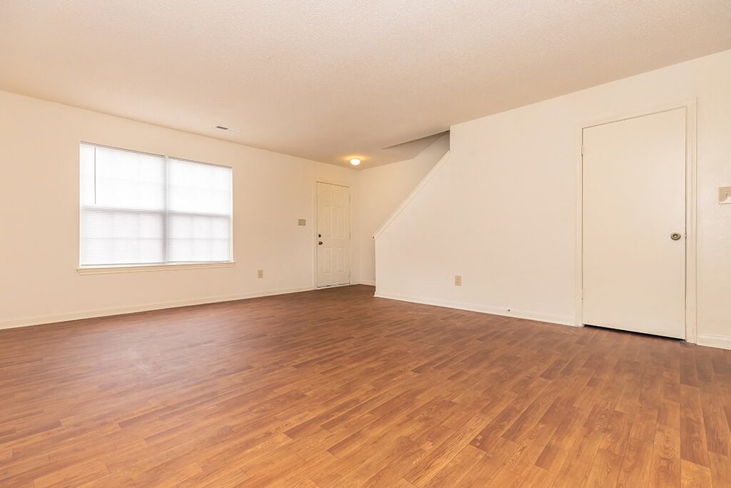 Living room with hardwood flooring at Greens of Pine Glen in Durham NC