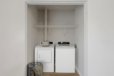 A small laundry room with a washer and dryer.