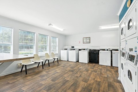 Laundry center with seating at Newport Apartment Homes in Nashville TN