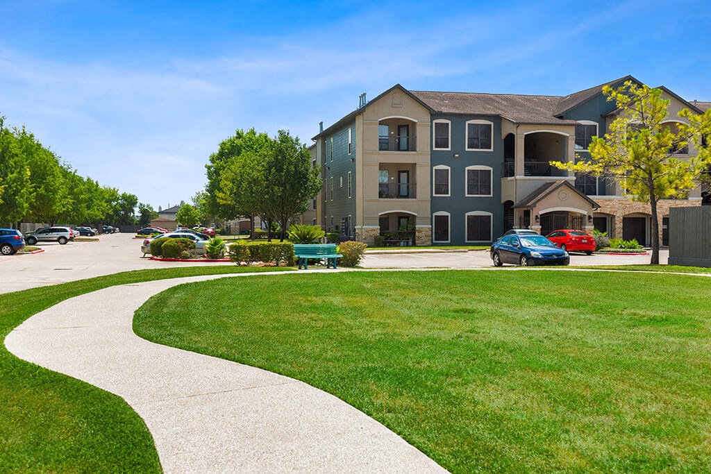 Lush lawn walkway at Parkway Senior Apartments in Pasadena TX