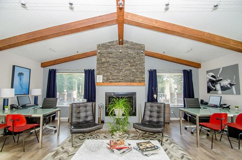 a living room with a fireplace and a table with chairs