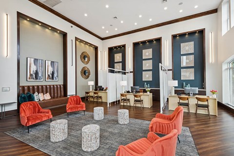 a living room with orange chairs and a rug