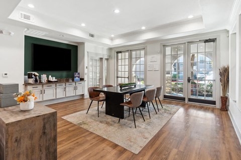 A modern dining room with a black table and chairs.
