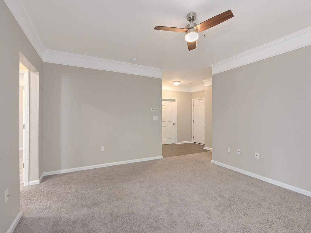 Living room with ceiling fan at Falls Pointe Apartments in Durham NC