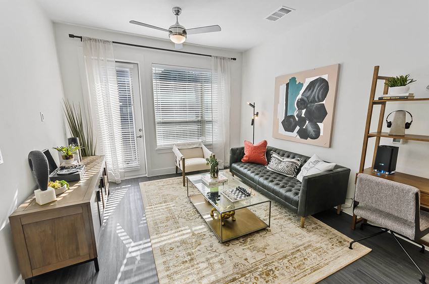 Living room with ceiling fan at Opal Legacy Central in Plano TX - Photo Gallery