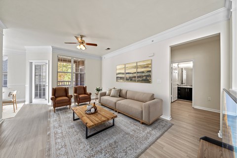 A living room with a couch, chairs, and a coffee table.