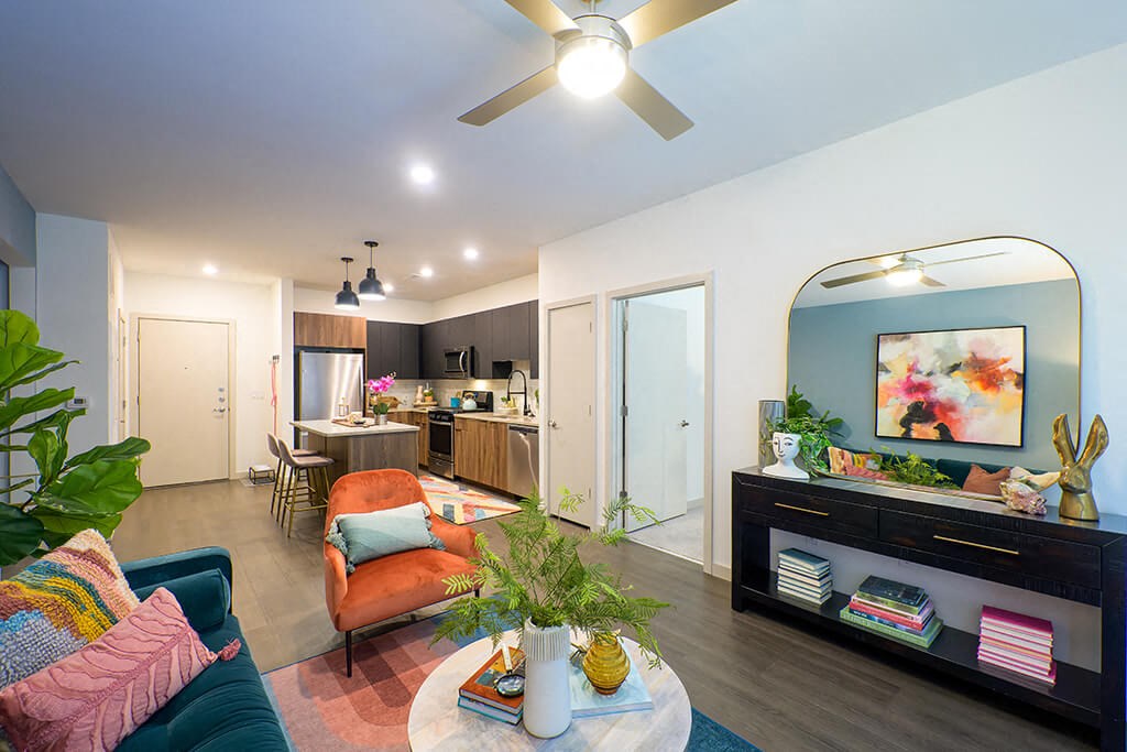 a living room with a couch and a ceiling fan