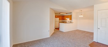 Living room with view of kitchen at Riverwoods, Riverwoods at Towne Square, and Riverwoods at Lake Ridge in Woodbridge VA