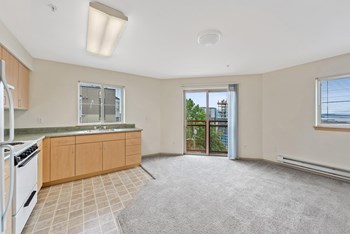 Carpeted living room and kitchen at Washington Terrace in Seattle WA - Photo Gallery 2