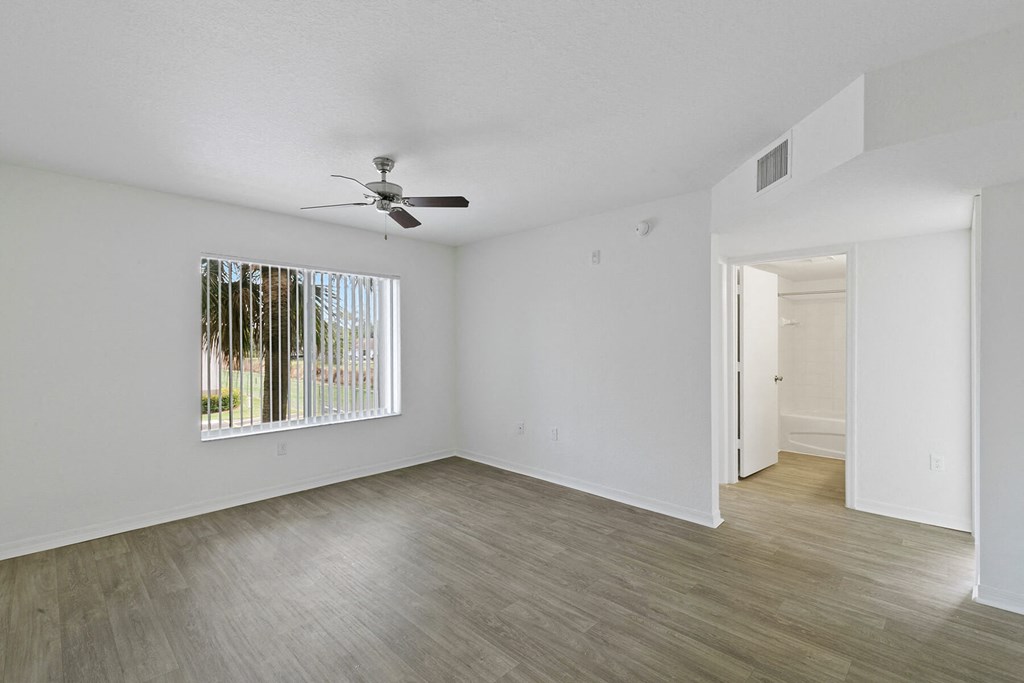 Living room with view of hallway at Brenton at Abbey Park Apartments in West Palm Beach FL