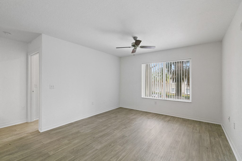 Living room with ceiling fan at Brenton at Abbey Park Apartments in West Palm Beach FL