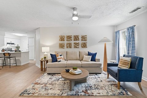Living room and view of kitchen at Chroma Park Apartments in Austell GA