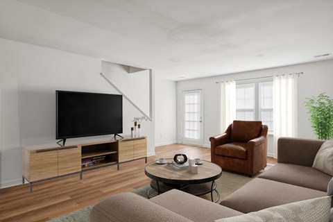 A living room with a brown leather chair and a black television.