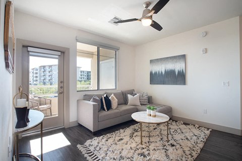 Living room with ceiling fan at District at Scottsdale Apartments in Scottsdale AZ
