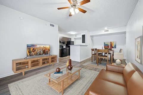 A living room with a brown leather couch and a wooden coffee table.
