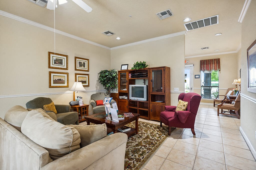 Lounge seating area with television at Parkway Senior Apartments in Pasadena TX