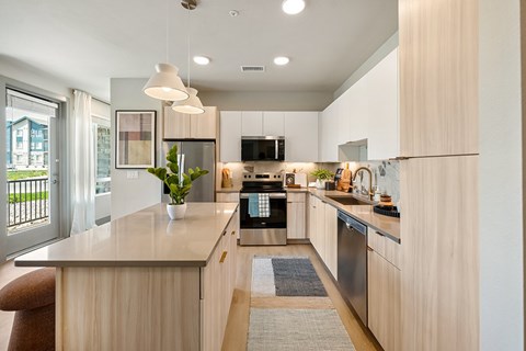 A modern kitchen with wooden cabinets and a large island.
