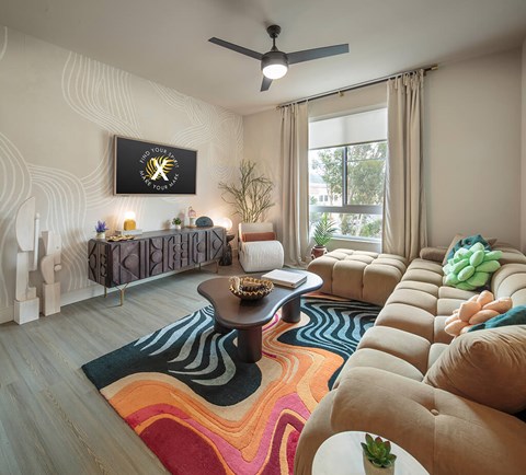 A living room with a large sectional sofa and a coffee table.