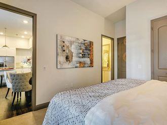Model Bedroom with living room view at The Huntington Apartments in Plano TX