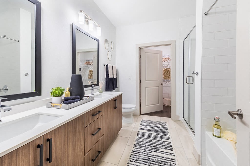 Bathroom with double sinks at 1900 Parmer Apartments in Austin TX