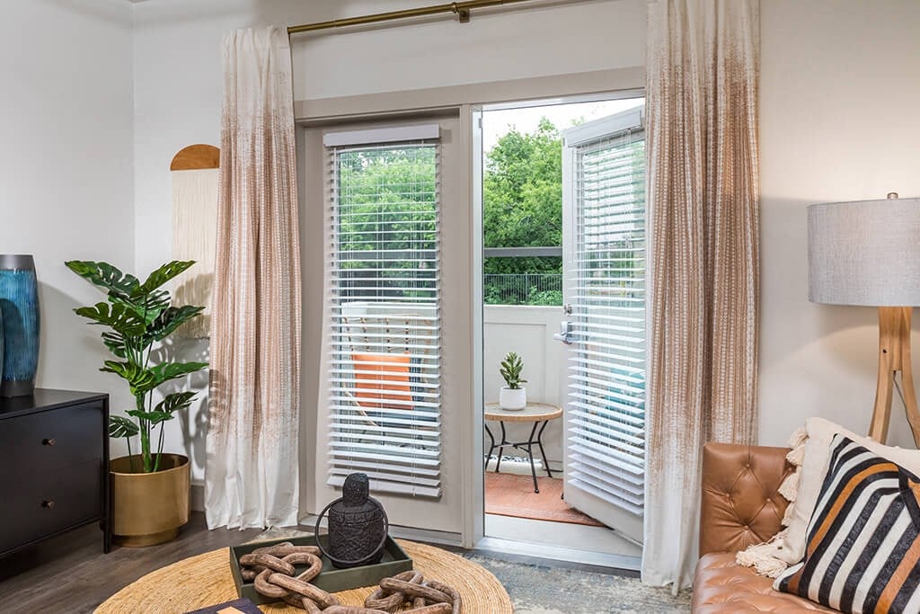 Living room with balcony at 1900 Parmer Apartments in Austin TX