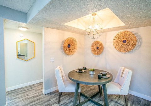 a dining room with a table and chairs