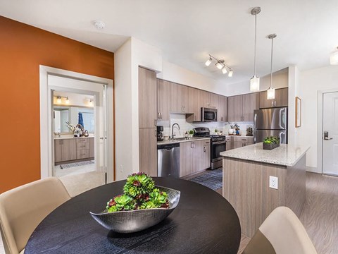 a kitchen and dining room with a salad on a table