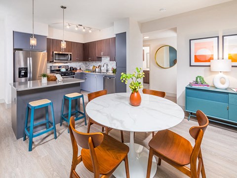a kitchen and dining room with a table and chairs