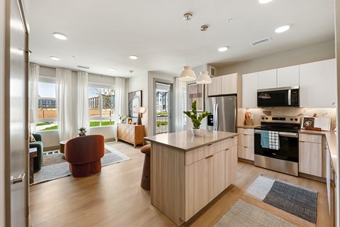 A modern kitchen with a large island and stainless steel appliances.