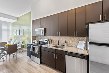 Kitchen with mocha cabinets at Bradley Braddock Road Station Apartments in Alexandria VA