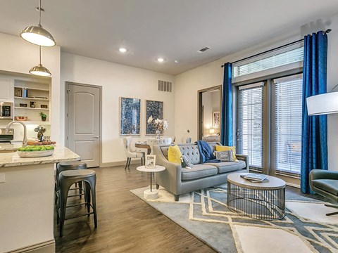 a living room and kitchen with a couch and a table