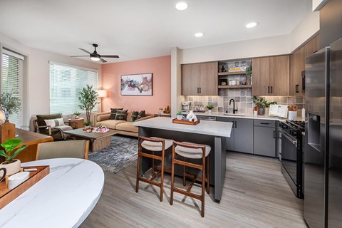 A modern kitchen with a breakfast bar and a dining area.