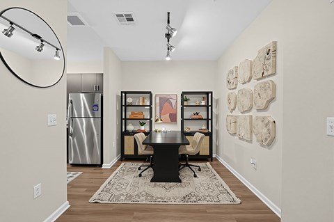 A kitchen with a fridge, a table and a chair.
