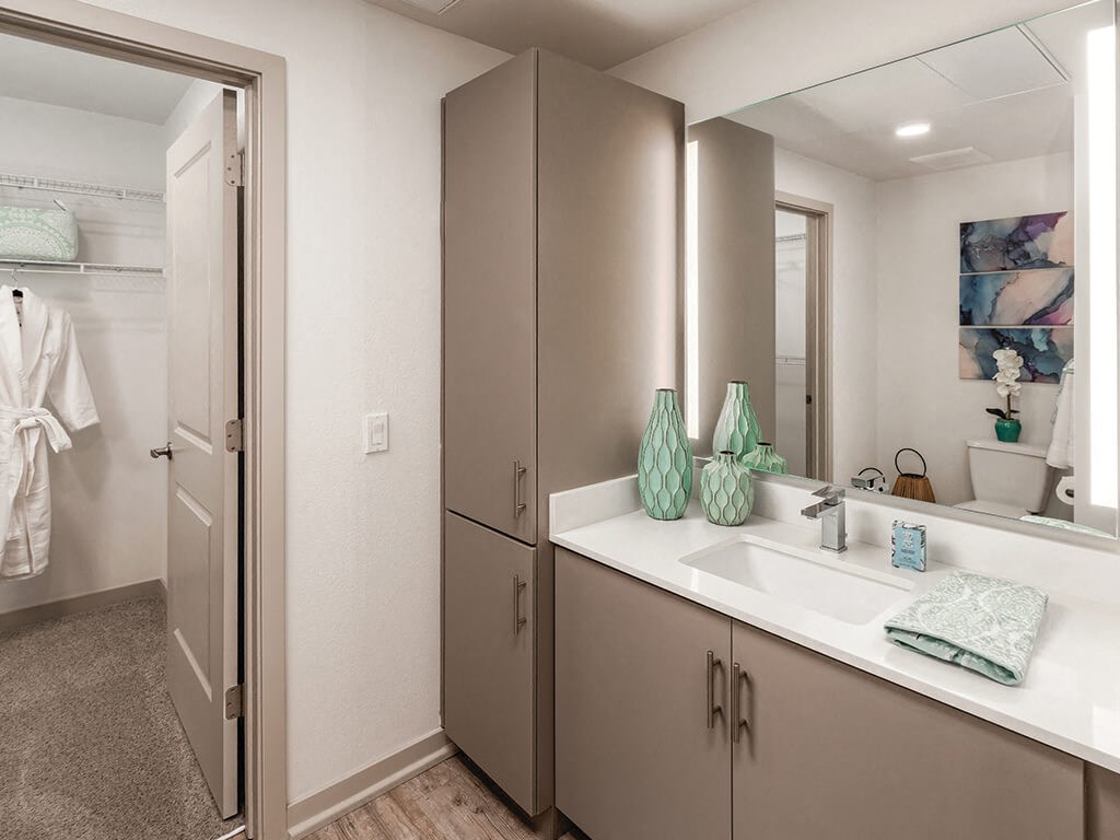 a bathroom with a sink and a mirror at Norte Town Lake Apartments in Tempe Arizona
